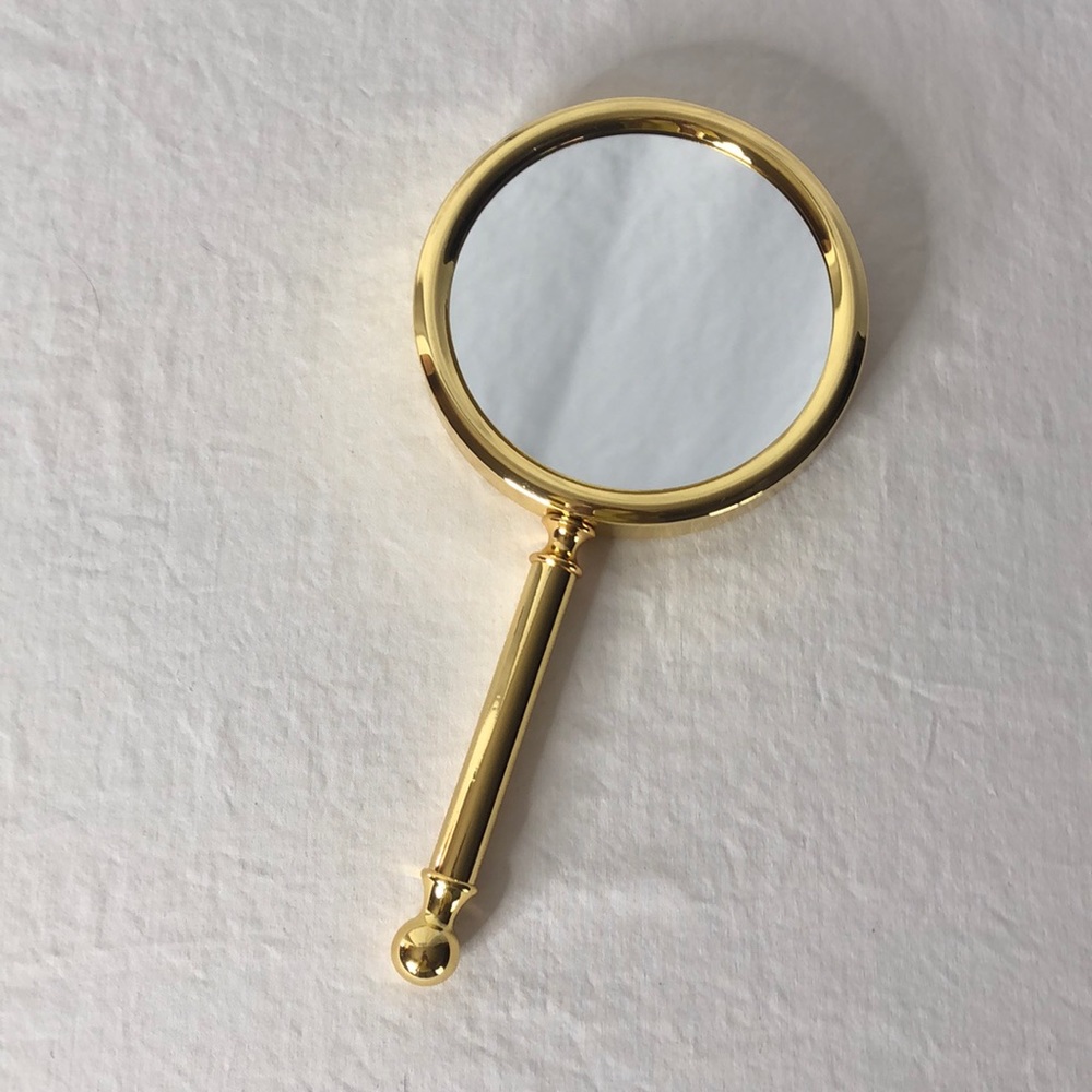 Umbra gold hand mirror regular and magnifying side